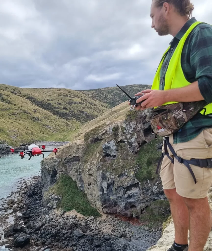 Manual drone spraying over cliff